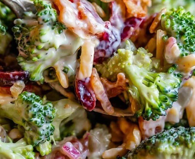 A vibrant bowl of the Best Broccoli Salad with fresh ingredients and dressing.