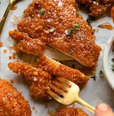 Cornflake-Crusted Chicken on a plate garnished with herbs