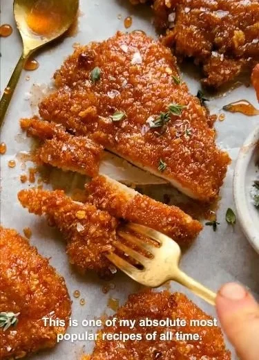 Cornflake-Crusted Chicken on a plate garnished with herbs