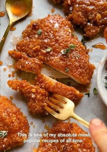 Cornflake-Crusted Chicken on a plate garnished with herbs