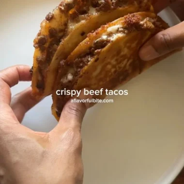 Plate of crispy ground beef tacos with fresh toppings