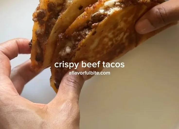 Plate of crispy ground beef tacos with fresh toppings