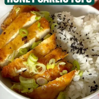 Plate of Honey Garlic Tofu garnished with green onions and sesame seeds
