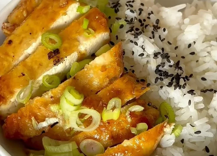 Plate of Honey Garlic Tofu garnished with green onions and sesame seeds