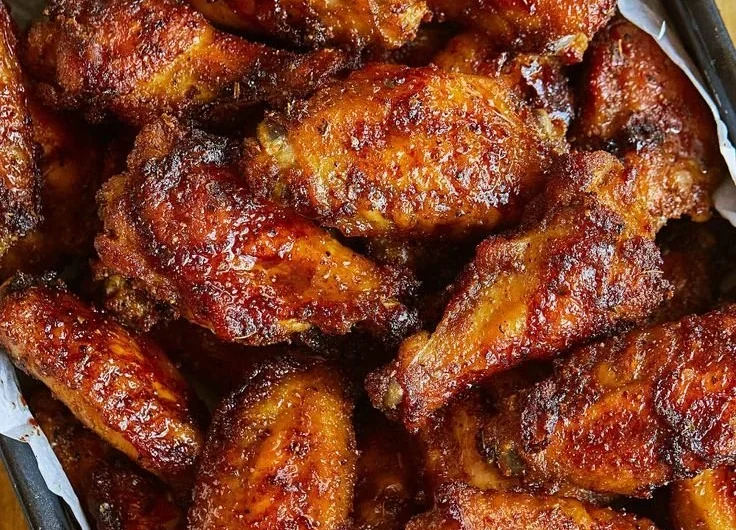 Delicious juicy chicken wings served on a plate
