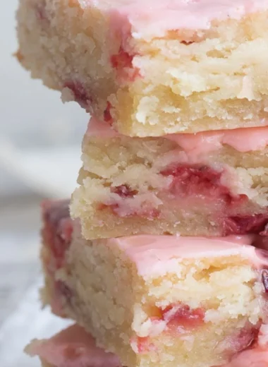 Delicious homemade strawberry bars on a wooden table