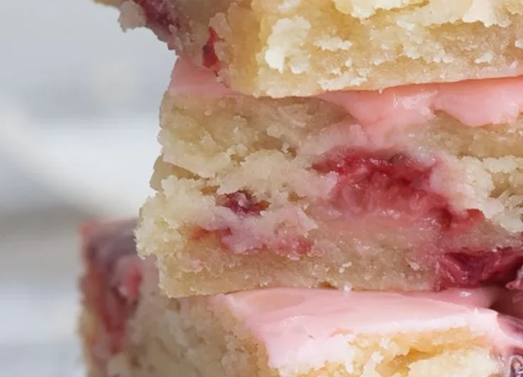 Delicious homemade strawberry bars on a wooden table