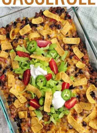Delicious Walking Taco Casserole topped with cheese, salsa, and crushed chips