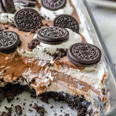 Delicious no bake Oreo dessert topped with Cool Whip and chocolate