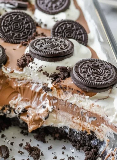 Delicious no bake Oreo dessert topped with Cool Whip and chocolate