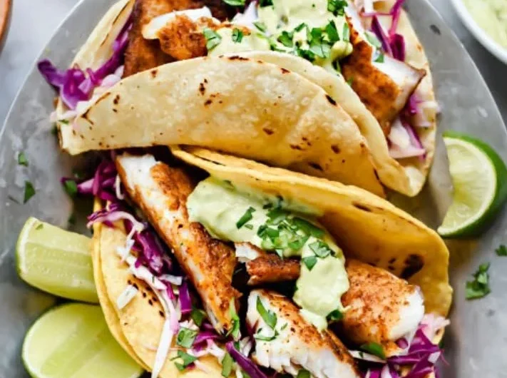 Blackened fish tacos served with a rich avocado cream sauce