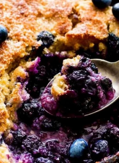 Delicious homemade blueberry cobbler topped with crispy crust and fresh blueberries