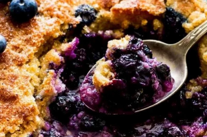 Delicious homemade blueberry cobbler topped with crispy crust and fresh blueberries