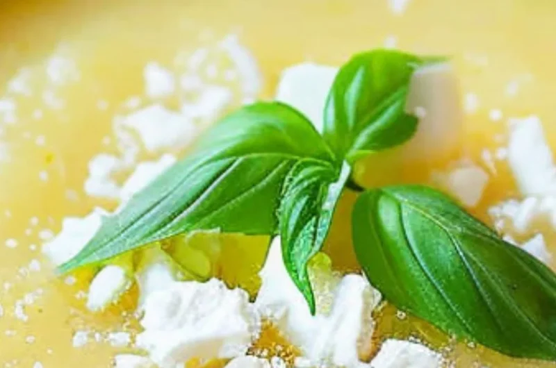 Chilled pineapple soup served in a bowl, garnished with mint leaves.
