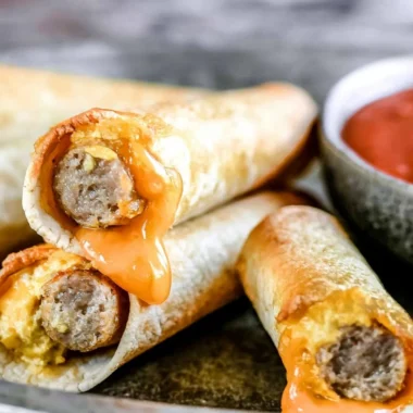 Delicious easy breakfast taquitos filled with eggs, cheese, and spices on a plate.
