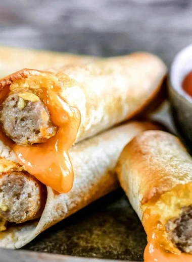 Delicious easy breakfast taquitos filled with eggs, cheese, and spices on a plate.