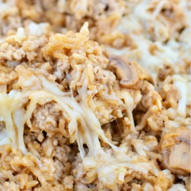 Easy ground turkey skillet casserole topped with cheese and vegetables