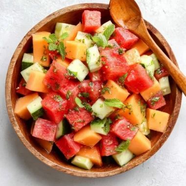 Bowl of easy melon salad with honey lime dressing and fresh fruits