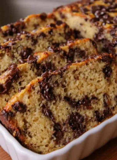 High protein Greek yogurt banana bread with chocolate chips on a rustic table