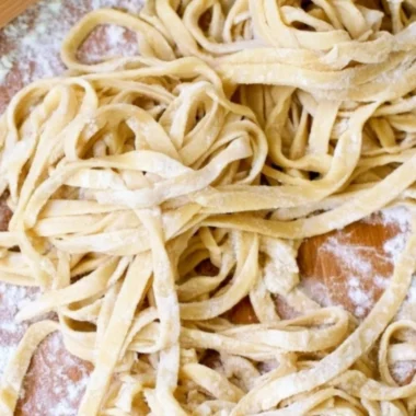 Plate of homemade egg noodles ready to serve with delicious sauces.