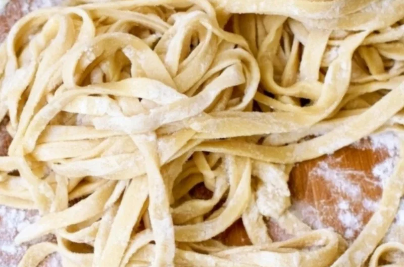 Plate of homemade egg noodles ready to serve with delicious sauces.