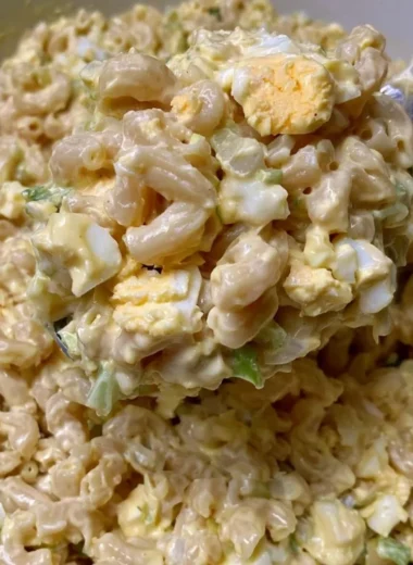 Bowl of Mom's Macaroni Salad with colorful vegetables and creamy dressing