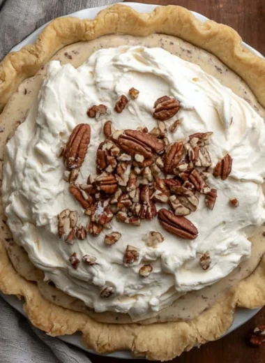 Delicious homemade Pecan Cream Pie topped with whipped cream and pecans