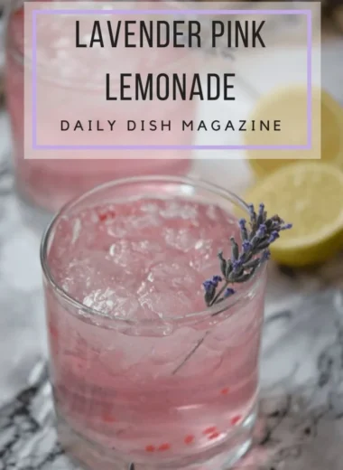 A refreshing glass of pink lavender lemonade garnished with fresh lavender sprigs.