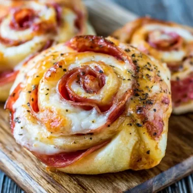 A plate of crispy and delicious homemade pizza rolls served with dipping sauce.