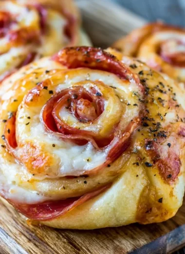 A plate of crispy and delicious homemade pizza rolls served with dipping sauce.