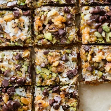 Delicious seven layer bars with chocolate, coconut, and nuts stacked in layers.