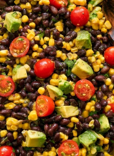 Vegan black bean salad with fresh vegetables and herbs in a bowl