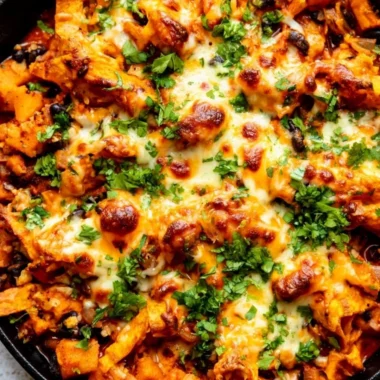 Butternut squash and black bean enchilada skillet topped with cheese and cilantro