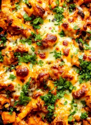 Butternut squash and black bean enchilada skillet topped with cheese and cilantro