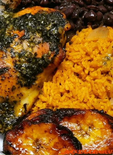 Cozy chicken yellow rice with black beans served in a colorful bowl.
