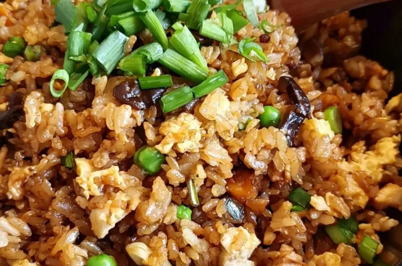Delicious plate of cozy Chinese Egg Fried Rice garnished with vegetables