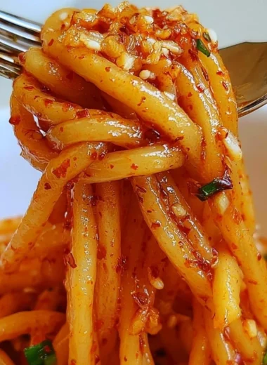 Delicious cozy garlic chili oil noodles garnished with chili flakes and herbs