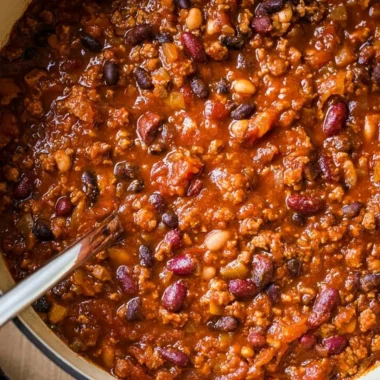 Bowl of cozy ground turkey chili topped with fresh herbs and served with tortilla chips.