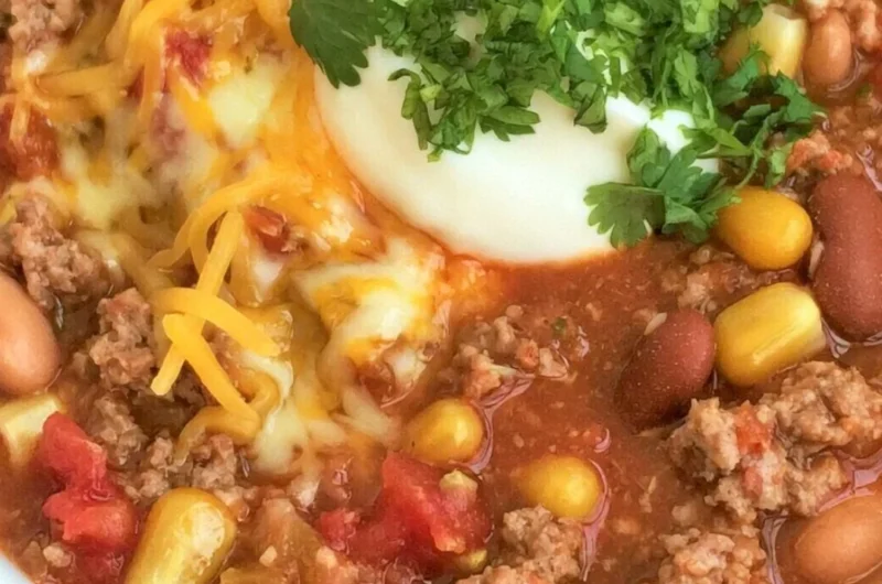 A bowl of cozy taco soup garnished with cilantro and cheese