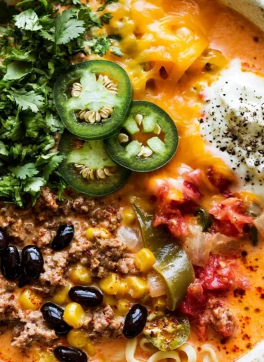 Creamy taco soup in a bowl topped with cheese and cilantro