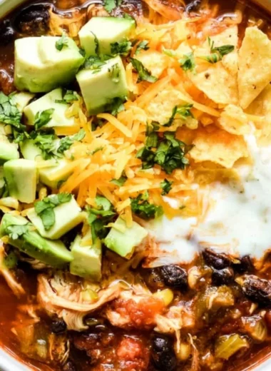Bowl of delicious Crockpot chicken enchilada soup topped with cheese and cilantro