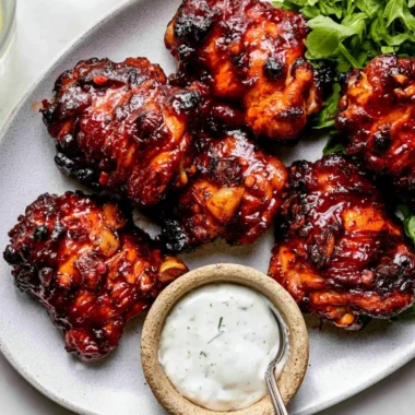 A delicious plate of Honey Harissa Chicken garnished with herbs