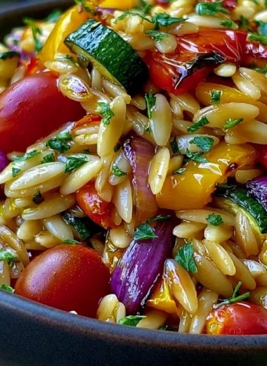 Bowl of delicious roasted vegetable orzo with vibrant veggies and herbs