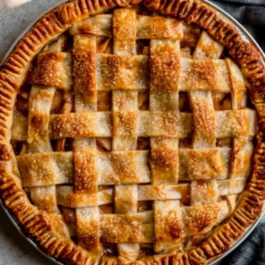 Homemade caramel apple pie with a flaky crust and drizzled caramel