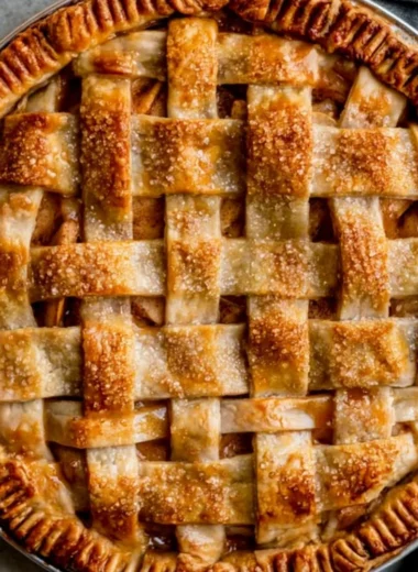 Homemade caramel apple pie with a flaky crust and drizzled caramel