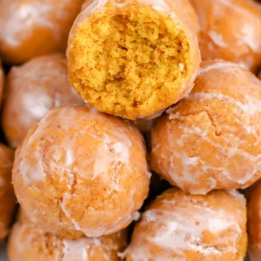 Cozy pumpkin donut holes dusted with sugar on a plate