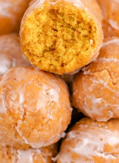Cozy pumpkin donut holes dusted with sugar on a plate