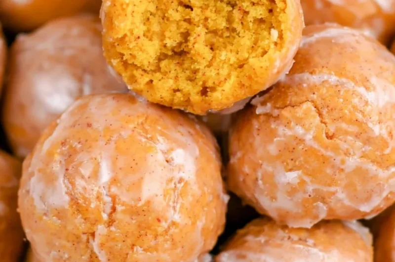 Cozy pumpkin donut holes dusted with sugar on a plate