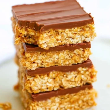 Healthy chocolate peanut butter oatmeal bars on a wooden table.