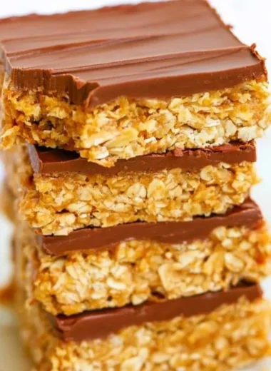 Healthy chocolate peanut butter oatmeal bars on a wooden table.